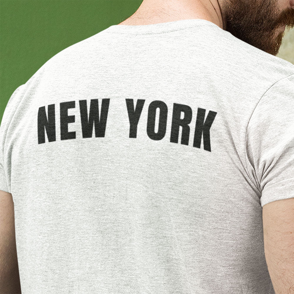 Person wearing a gray t-shirt with 'NEW YORK' printed on the back against a green background